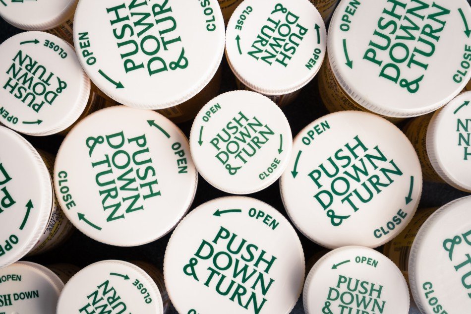 Tops of pill bottles, which say "Push Down & Turn".